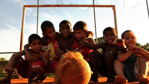Group of kids enjoying a lively game of soccer in a Rio de Janeiro neighborhood.