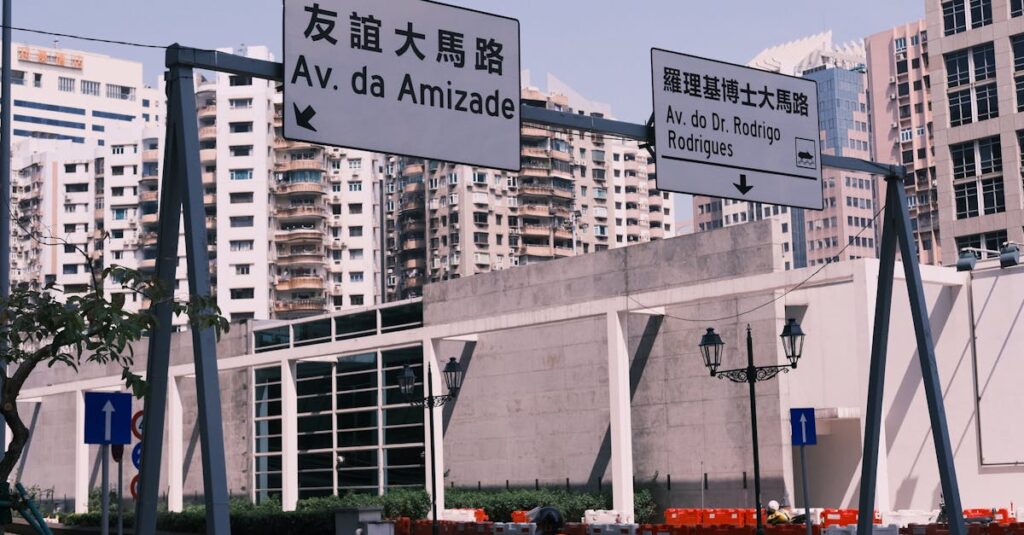 Street view in Macau with bilingual road signs and urban architecture.