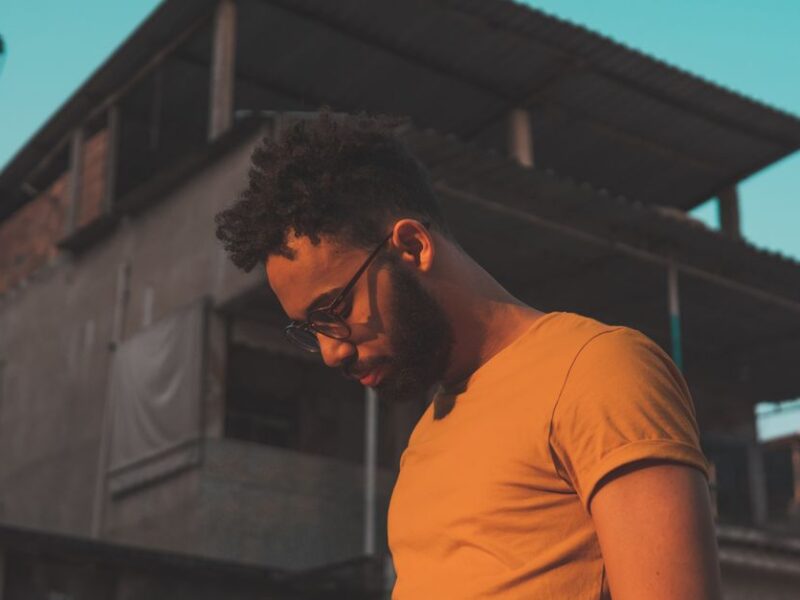 Portrait of a man with a beard and glasses in Rio de Janeiro, Brazil's urban environment.
