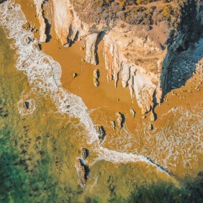 A stunning aerial view of the rugged coastline at Goleta, California with turquoise waters and rocky cliffs.
