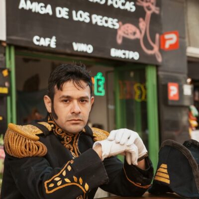 A man in a naval uniform poses at an outdoor cafe in Buenos Aires, Argentina.