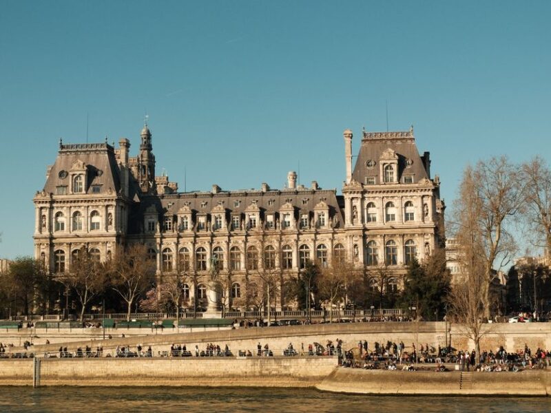 Elegant view of a classic Parisian building along the Seine River on a clear day.