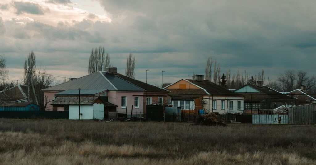 Quiet rural scene with houses under a cloudy sky in Semennoi, Saratov Oblast, Russia.