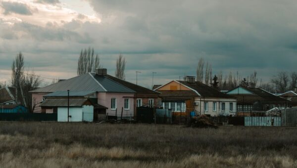 Quiet rural scene with houses under a cloudy sky in Semennoi, Saratov Oblast, Russia.
