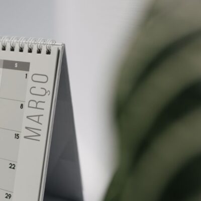 A close-up shot of a desk calendar open on March, with a soft, minimalistic background.