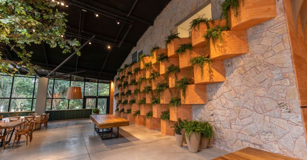 A spacious restaurant interior featuring brick wall design and indoor plants for a natural ambiance.