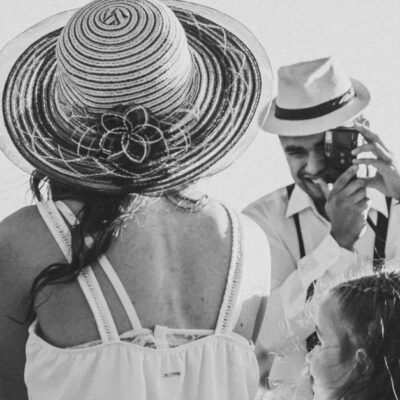 A black and white family portrait of a couple and child overlooking Sorocaba, Brazil on a sunny day.
