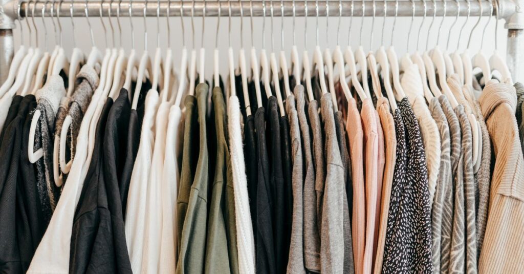 Neatly arranged clothing on hangers showcasing a variety of fabrics and styles.