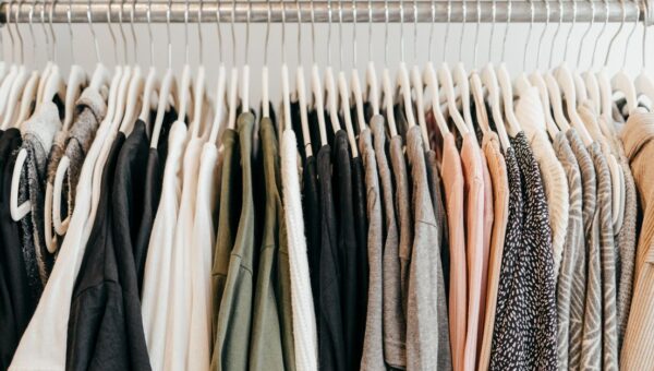 Neatly arranged clothing on hangers showcasing a variety of fabrics and styles.