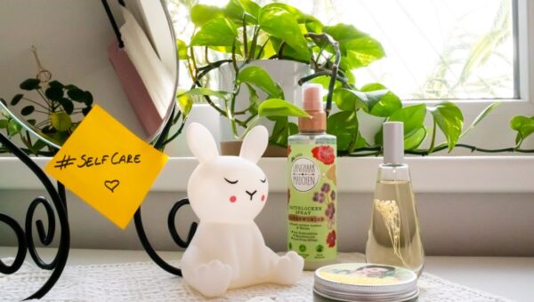 A soothing self-care corner with a bunny lamp, cosmetics, and a mirror, perfect for a relaxing routine.
