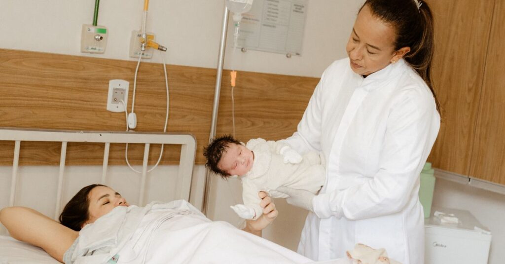A doctor assists a new mother with her newborn baby in a hospital room setting.