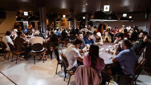 Intense poker game in a lively casino with multiple players. Experience the thrill and strategy of poker.