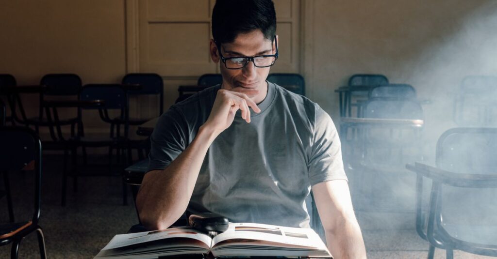 Student reading a book in a sunlit classroom in Buenos Aires. Perfect for educational themes.