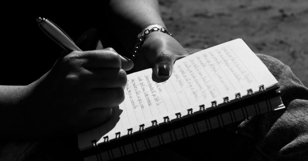 Close-up of a person writing in a notebook, captured in Mar del Plata, Argentina.