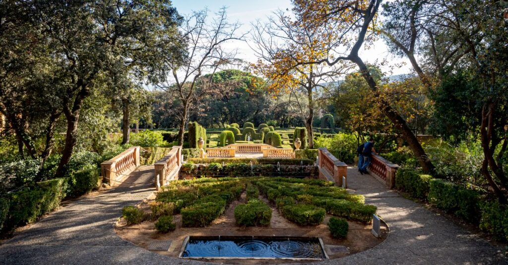 Explore the tranquil beauty of Parc del Laberint d'Horta in Barcelona, showcasing its elegant topiary and sunlit pathways.