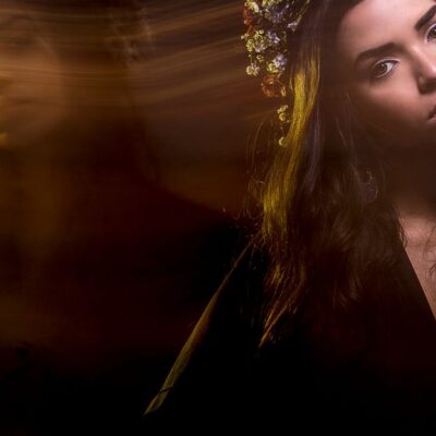 A creative portrait of a woman using long exposure, capturing artistic motion and ambient light.