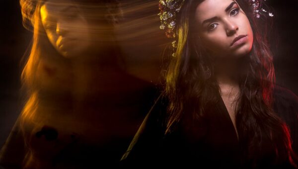 A creative portrait of a woman using long exposure, capturing artistic motion and ambient light.