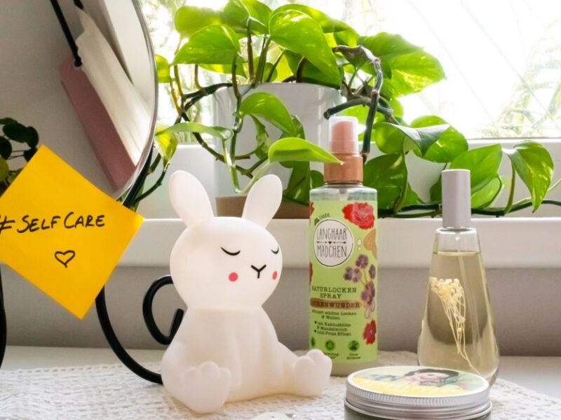 A soothing self-care corner with a bunny lamp, cosmetics, and a mirror, perfect for a relaxing routine.