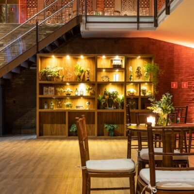An elegant modern lounge with an illuminated staircase and stylish indoor plants.
