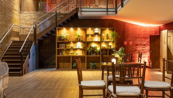 An elegant modern lounge with an illuminated staircase and stylish indoor plants.