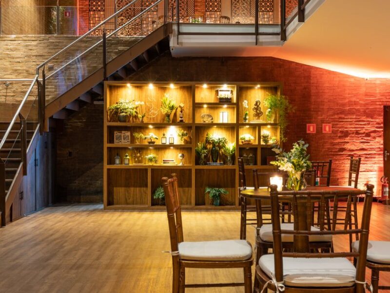 An elegant modern lounge with an illuminated staircase and stylish indoor plants.