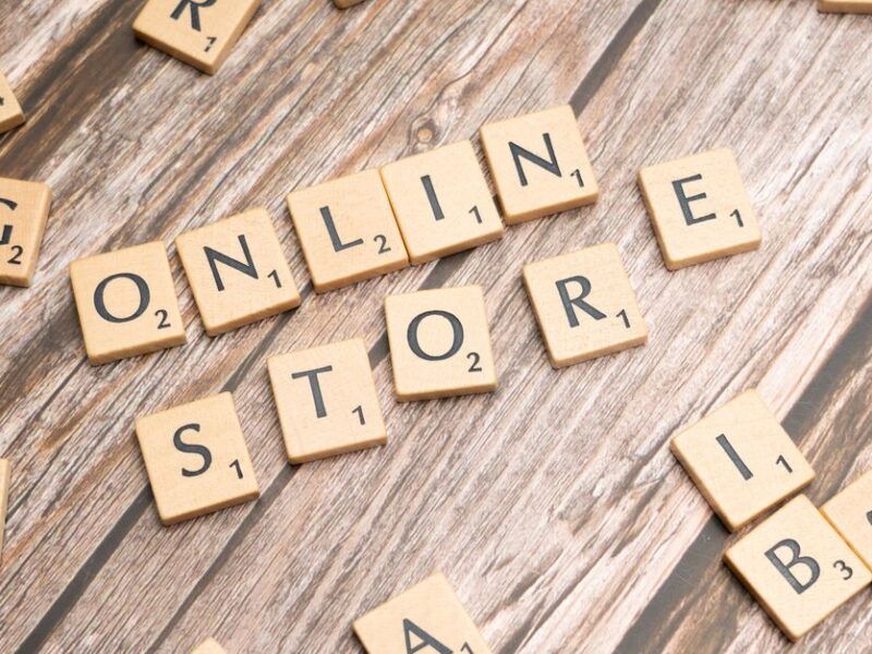 Scrabble tiles spelling 'online store' on a rustic wooden background.