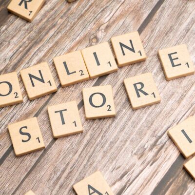 Scrabble tiles spelling 'online store' on a rustic wooden background.