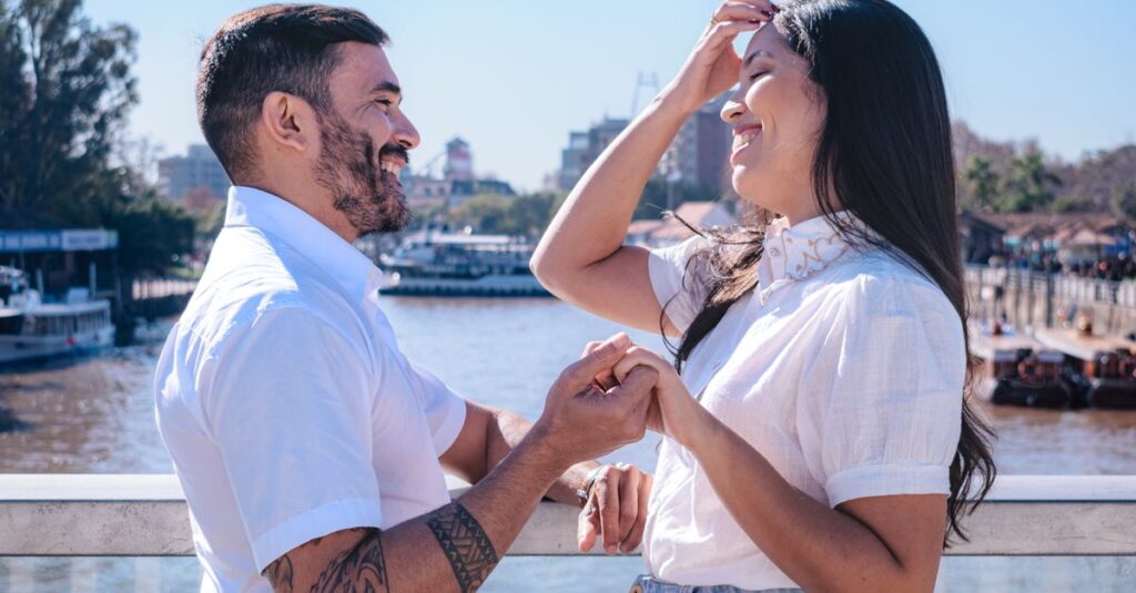 Joyful couple sharing a happy moment on a riverside bridge in Tigre, Buenos Aires Province, Argentina.