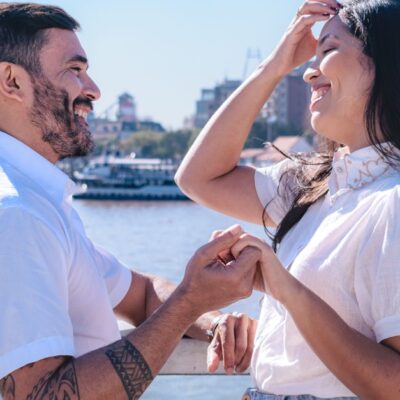 Joyful couple sharing a happy moment on a riverside bridge in Tigre, Buenos Aires Province, Argentina.