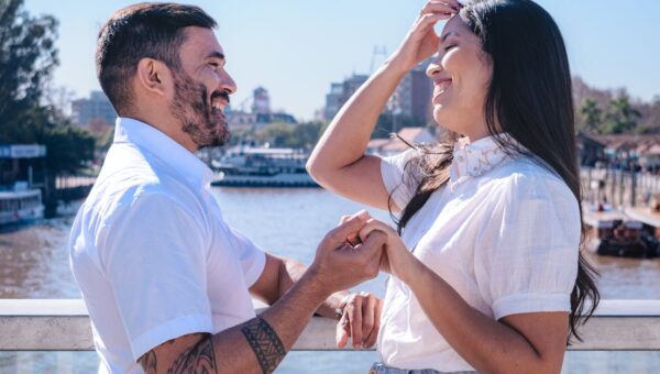 Joyful couple sharing a happy moment on a riverside bridge in Tigre, Buenos Aires Province, Argentina.