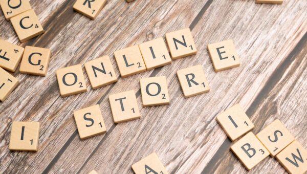 Scrabble tiles spelling 'online store' on a rustic wooden background.