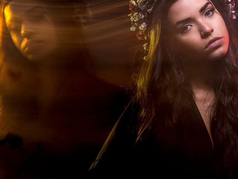 A creative portrait of a woman using long exposure, capturing artistic motion and ambient light.